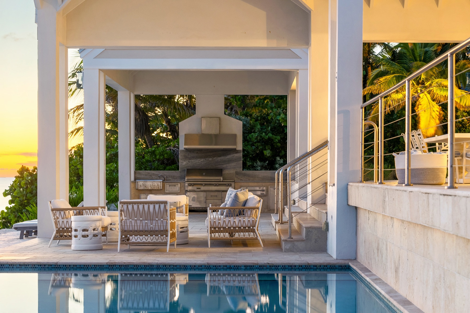 Covered terrace and pool at sunset